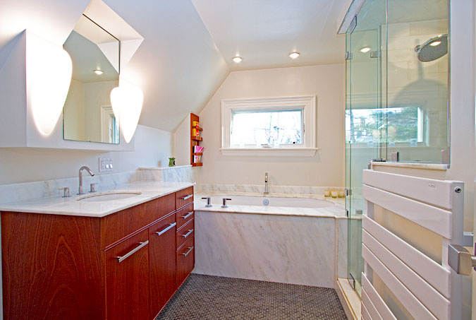 Detail of a marble and mahogany bathroom vanity with hand-fitted stone and wood joinery
