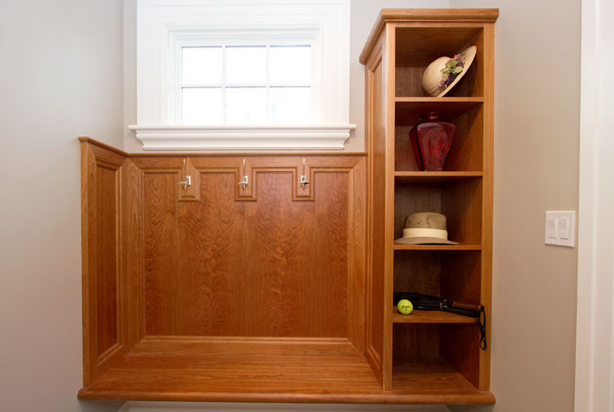 Cherry mud room built-in with bench, cubbies, and hooks